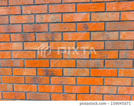 Brick wall with a mix of red and brown bricks in a simple arrangement during daylight 139045871