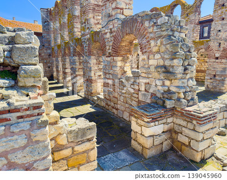 Ancient ruins in a historical site showing stone structures under bright sunlight during the day in a quiet location Ancient ruins in a historical site showing stone structures under bright sunlight during the day in a quiet location 139045960