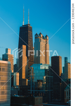 Skyline of Chicago shows modern buildings and architectural designs during sunset with clear blue sky Skyline of Chicago shows modern buildings and architectural designs during sunset with clear blue sky 139046144