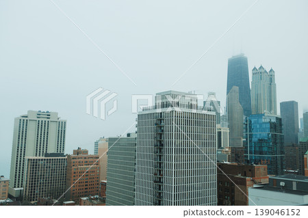 City skyline shows tall buildings under cloudy sky during early morning hours in urban area City skyline shows tall buildings under cloudy sky during early morning hours in urban area 139046152