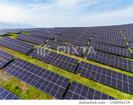 Solar panels cover a large field in a renewable energy site where energy is generated during the day in a sunny location Solar panels cover a large field in a renewable energy site where energy is generated during the day in a sunny location 139046254
