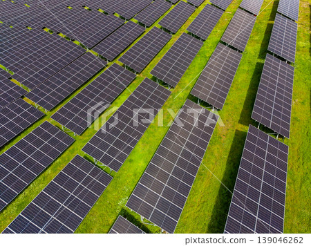 Solar panels cover large field in bright daylight for energy generation Solar panels cover large field in bright daylight for energy generation 139046262