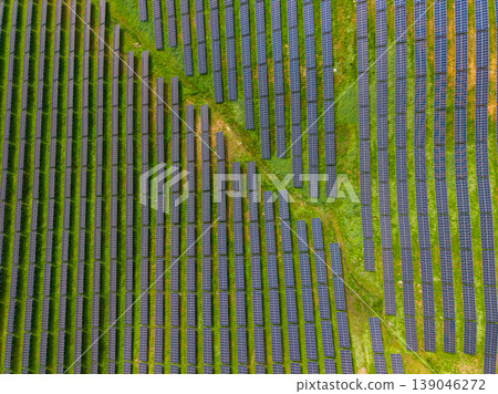 Solar panels spread across a large field in a rural area during a clear day showcasing renewable energy efforts and technology development Solar panels spread across a large field in a rural area during a clear day showcasing renewable energy efforts and technology development 139046272