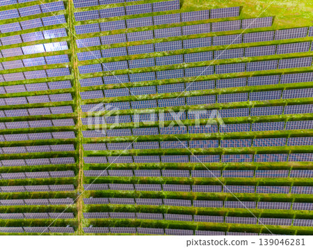 Rows of solar panels in a green field show renewable energy efforts in sunny weather during daytime Rows of solar panels in a green field show renewable energy efforts in sunny weather during daytime 139046281