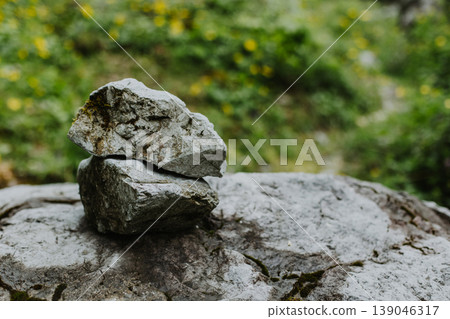 Two stones one in on top of the other on a natural background. Two stones one in on top of the other on a natural background. 139046317