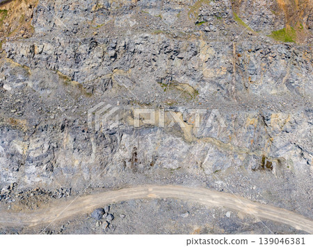 Granite quarry site showing rock formations and access road during daylight hours Granite quarry site showing rock formations and access road during daylight hours 139046381
