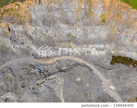 Granite quarry shows extraction process and landscape features at different levels during daylight Granite quarry shows extraction process and landscape features at different levels during daylight 139046405
