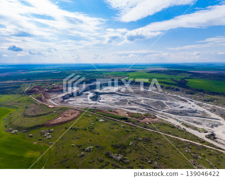 Granite quarry located in a rural area with visible land use changes and machinery during a sunny day 139046422
