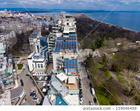 View of urban buildings with solar panels and coastal area near city skyline on a clear day in springtime 139046488