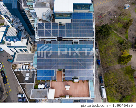 Buildings in urban area showcase solar panels on rooftops to harness clean energy and promote sustainability during the daytime Buildings in urban area showcase solar panels on rooftops to harness clean energy and promote sustainability during the daytime 139046489