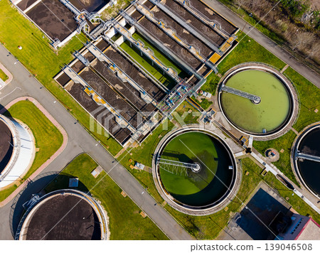 Water treatment facility with multiple tanks and filtration systems located in an industrial area during daylight hours Water treatment facility with multiple tanks and filtration systems located in an industrial area during daylight hours 139046508