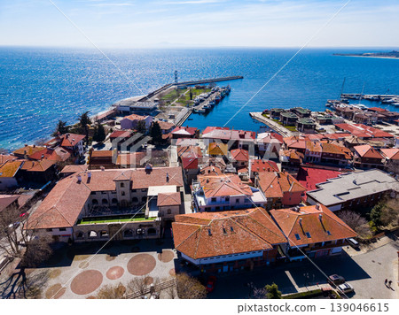 View of a coastal town by the sea with boats and buildings during a clear sunny day in springtime View of a coastal town by the sea with boats and buildings during a clear sunny day in springtime 139046615