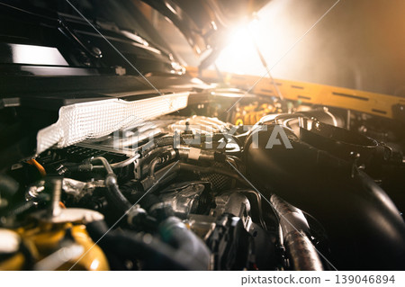 Open modern diesel car engine under hood with dramatic lighting. Automotive engineering, powertrain detail and professional service concept. Open modern diesel car engine under hood with dramatic lighting. Automotive engineering, powertrain detail and professional service concept. 139046894