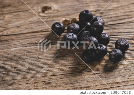 Top View of Blueberries on Wooden Background. Fresh Blueberries on Wooden Surface. Top View of Blueberries on Wooden Background. Fresh Blueberries on Wooden Surface. 139047038