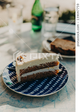 Delicious cake on a plate in a cafe. Daylight. 139047759