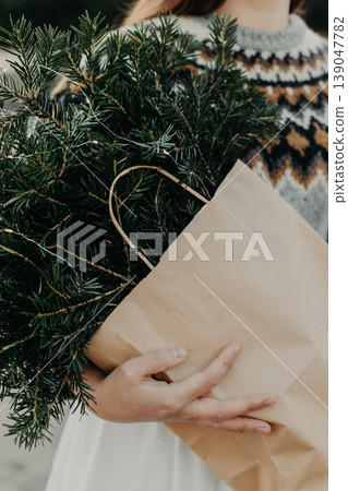 Bouquet of spruce branches with Christmas lights in a female hands. Bouquet of spruce branches with Christmas lights in a female hands. 139047782