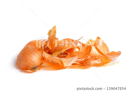 Dry golden onion skin pile on white background Dry golden onion skin pile on white background 139047854