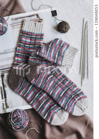 Hand knitted socks with needles and yarn ball. Concept for handmade and hygge slow life. Hand knitted socks with needles and yarn ball. Concept for handmade and hygge slow life. 139048053