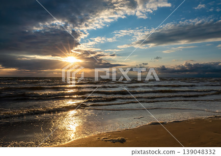 Sunset over the sea, a spring storm and rain clouds over the horizon, a seascape with copy space for text advertising off-season travel to the Mediterranean 139048332