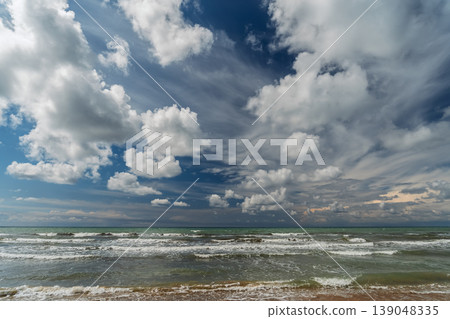 Invitation to a trip to the Mediterranean Sea, a magnificent spring storm and beautiful clouds in the blue sky, a poster concept for Earth Day and environmental awareness Invitation to a trip to the Mediterranean Sea, a magnificent spring storm and beautiful clouds in the blue sky, a poster concept for Earth Day and environmental awareness 139048335