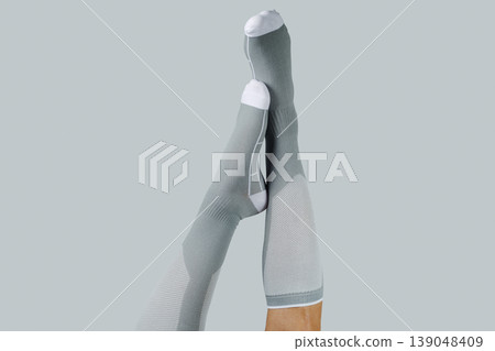 crossed legs upside down in compression socks crossed legs upside down in compression socks 139048409