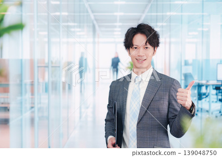 A young man working in a modern office A young man working in a modern office 139048750