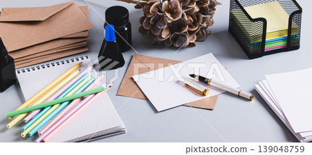 Fountain pen, ink, paper and envelopes for handwriting on the table web banner Fountain pen, ink, paper and envelopes for handwriting on the table web banner 139048759