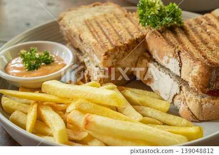 Close up photo of grilled sandwiches with melted cheese on a wooden rustic board Close up photo of grilled sandwiches with melted cheese on a wooden rustic board 139048812