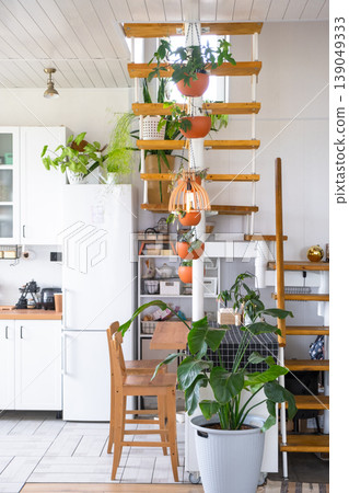 Compact modular wooden staircase in kitchen, open space with abundant green plants, loft design, eco-friendly details, daylight and cozy home style. Compact modular wooden staircase in kitchen, open space with abundant green plants, loft design, eco-friendly details, daylight and cozy home style. 139049333