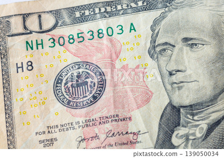 American dollar bills in close-up, showing the image of the president on the banknotes. 139050034