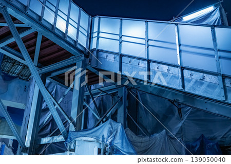 Shibuya Station at night: Temporary walkway (stairs) at a construction site. 139050040