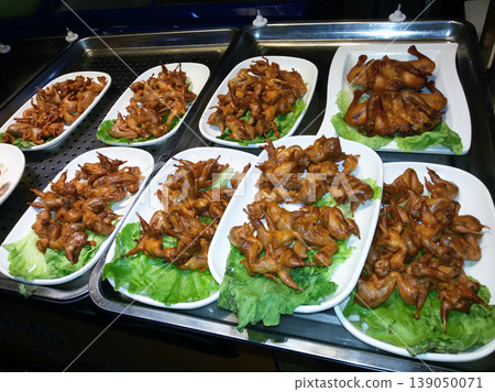 Roasted small birds or quails served on plates at a street food market. Roasted small birds or quails served on plates at a street food market. 139050071
