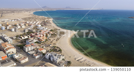 Aerial view of Sal Rei town sandy beach and yacht moored in the shore Aerial view of Sal Rei town sandy beach and yacht moored in the shore 139050110