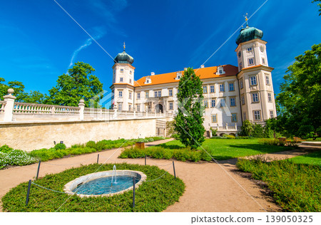 Historical chateau at Mnisek pod Brdy city, Czech Republic. View of ancient building with towers, built in gothic style. Sunny summer day, blue sky and vibrant colors. 139050325