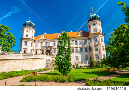 Historical chateau at Mnisek pod Brdy city, Czech Republic. View of ancient building with towers, built in gothic style. Sunny summer day, blue sky and vibrant colors. Historical chateau at Mnisek pod Brdy city, Czech Republic. View of ancient building with towers, built in gothic style. Sunny summer day, blue sky and vibrant colors. 139050326