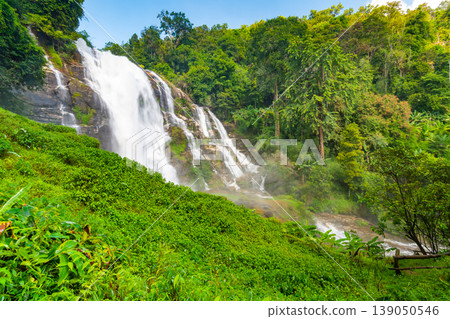 Wachirathan Waterfall at Doi Inthanon National Park, Mae Chaem District, Chiang Mai Province, Thailand. Fresh flowing water in tropical rainforest. Green trees, vibrant colors, tranquility 139050546