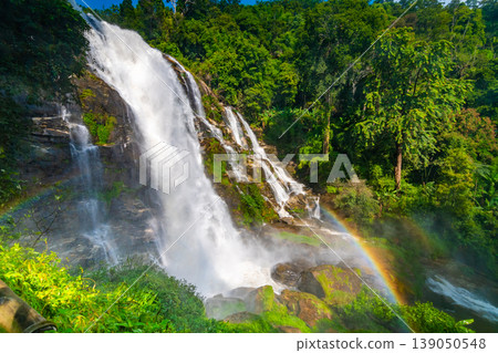 Wachirathan Waterfall at Doi Inthanon National Park, Mae Chaem District, Chiang Mai Province, Thailand. Fresh flowing water in tropical rainforest. Green trees, vibrant colors, tranquility Wachirathan Waterfall at Doi Inthanon National Park, Mae Chaem District, Chiang Mai Province, Thailand. Fresh flowing water in tropical rainforest. Green trees, vibrant colors, tranquility 139050548