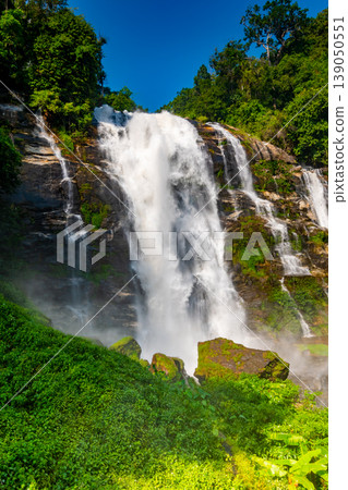 Wachirathan Waterfall at Doi Inthanon National Park, Mae Chaem District, Chiang Mai Province, Thailand. Fresh flowing water in tropical rainforest. Green trees, vibrant colors, tranquility 139050551