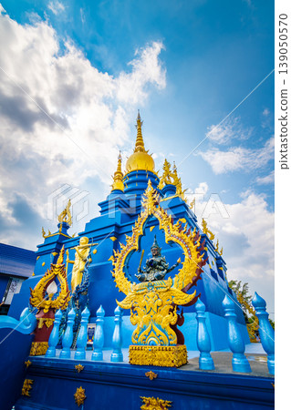 Beautiful blue pagoda at Wat Rong Suea Ten Temple, also known as the Blue Temple. Wat Rong Suea Ten or the Tiger Temple is located near Chiang Rai city, Thailand. Blue sky with dramatic dynamic clouds Beautiful blue pagoda at Wat Rong Suea Ten Temple, also known as the Blue Temple. Wat Rong Suea Ten or the Tiger Temple is located near Chiang Rai city, Thailand. Blue sky with dramatic dynamic clouds 139050570