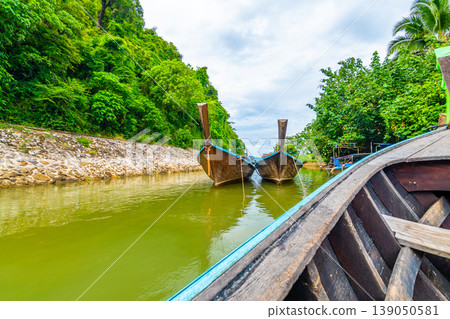 View from long tailed boat in Krabi town, Thailand. Boats are prepared for passenger to famou Railay beach. Boats are traditional transportation way to islands at Andaman sea near coast View from long tailed boat in Krabi town, Thailand. Boats are prepared for passenger to famou Railay beach. Boats are traditional transportation way to islands at Andaman sea near coast 139050581