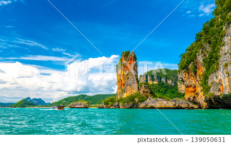 View from boat going to famous Railay beach in Krabi town, Thailand. Favorite place in Thailand with pure sea, white sand and beautiful limestone rocks. Vacation target in tropical paradise. 139050631