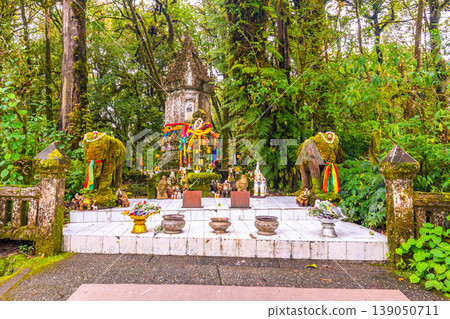 Memorial shrine at Doi Inthanon tropical rainforest park. Elephant statues on the sides as memento of king visit Memorial shrine at Doi Inthanon tropical rainforest park. Elephant statues on the sides as memento of king visit 139050711