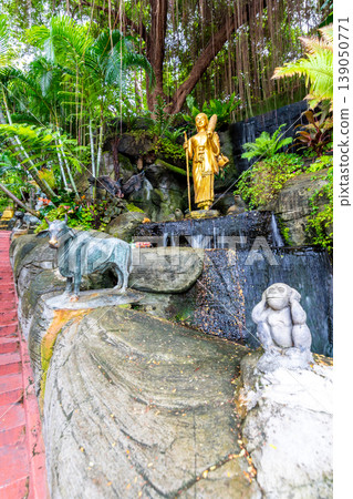 Stars leading to the Wat Saket temple (Golden mount) in Bangkok city, Thailand. Beautiful trees and plants with flowers on the side. Buddhism religion statues near the stairs. Spiritual place 139050771
