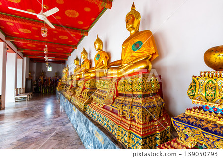 Statues of Buddha in Wat Pho temple, Bangkok Thailand. Golden statues are placed in row in ancient spiritual centre of Buddhism. Famous tourist destination in Asia Statues of Buddha in Wat Pho temple, Bangkok Thailand. Golden statues are placed in row in ancient spiritual centre of Buddhism. Famous tourist destination in Asia 139050793