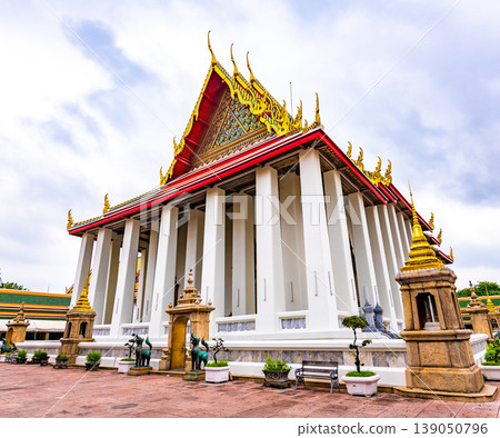 Wat Pho temple in Bangkok city, Thailand. Ancient buddhism temple, view of building with lying Buddha statue inside. Famous tourist destination. Religion building. Wat Pho temple in Bangkok city, Thailand. Ancient buddhism temple, view of building with lying Buddha statue inside. Famous tourist destination. Religion building. 139050796