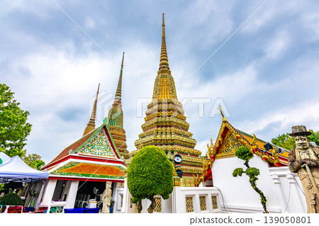 Wat Pho temple in Bangkok city, Thailand. View of pagoda and stupa in famous ancient temple. Religious buildings in buddhism style near Grand Palace. Oriental and Asian style, famous tourist target. Wat Pho temple in Bangkok city, Thailand. View of pagoda and stupa in famous ancient temple. Religious buildings in buddhism style near Grand Palace. Oriental and Asian style, famous tourist target. 139050801