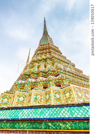 Closeup view of beautiful ceramic tiled stupa in Wat Pho temple, Bangkok, Thailand. Pagoda in oriental asian style is created from ceramic tiles. Famous tourist destination. Cloudy weather. 139050817