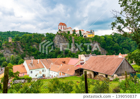 View of beautiful castle Vranov nad Dyji, Moravian region in Czech republic. Ancient chateau built in baroque style, placed on big rock above river near the Vranov village. Cloudy weather. View of beautiful castle Vranov nad Dyji, Moravian region in Czech republic. Ancient chateau built in baroque style, placed on big rock above river near the Vranov village. Cloudy weather. 139050837