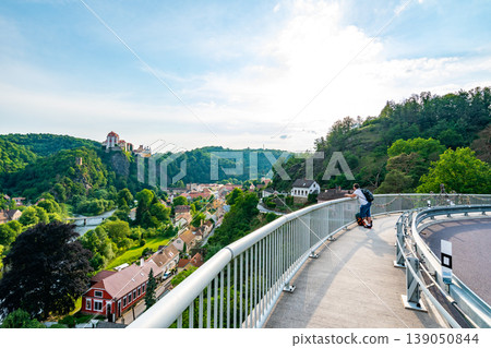 Young boy is looking from bridge in Vranov city to near Castle Young boy is looking from bridge in Vranov city to near Castle 139050844