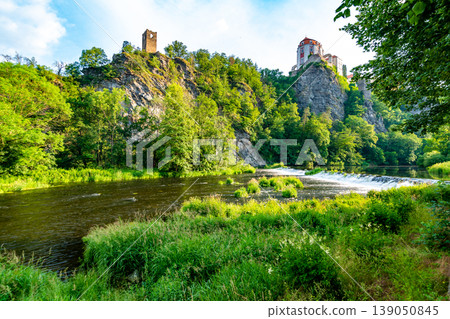 View of beautiful castle Vranov nad Dyji, Moravian region in Czech republic. Ancient chateau built in baroque style, placed on big rock above river near the Vranov village. Cloudy weather. View of beautiful castle Vranov nad Dyji, Moravian region in Czech republic. Ancient chateau built in baroque style, placed on big rock above river near the Vranov village. Cloudy weather. 139050845